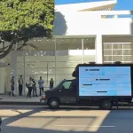A mobile LED truck sits outside a Los Angeles art gallery on a sunny day
