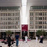 People walk in front of a building labeled