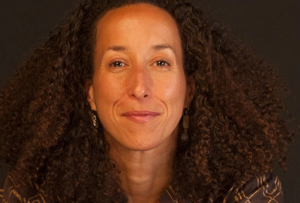 A woman with curly dark hair.