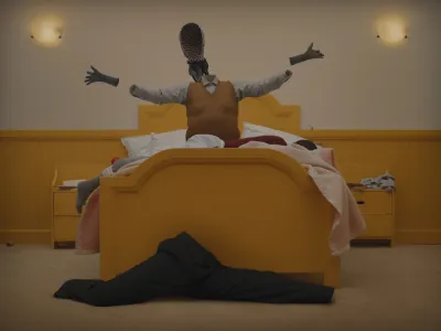A bed with a person lying in it, along with an invisible figure wearing clothes.