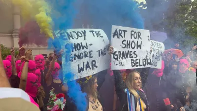 Crowds protest outside the Russia pavilion at the Venice Biennale. Signs read 
