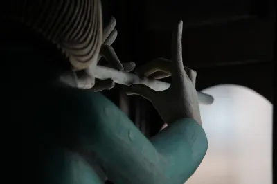 A doll with a flute seen from behind.