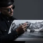 TOPSHOT - French photographer and street artist JR,  poses in his Paris studio on November 26, 2025, presenting "The Cave of the Pont Neuf," the artwork he will create as a tribute to Christo and Jeanne-Claude, transforming the Pont Neuf forty years after the wrapping of Paris