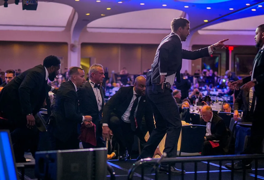 WASHINGTON, DC - APRIL 25: Health and Human Services Secretary Robert F. Kennedy Jr. (3rd-L) is taken out of the ballroom by security agents during a shooting incident at the annual White House Correspondents Association Dinner at the Washington Hilton on April 25, 2026 in Washington, DC. According to reports, President Donald Trump, along with other government officials, were evacuated from the Washington Hilton gun shots. (Photo by Andrew Harnik/Getty Images)