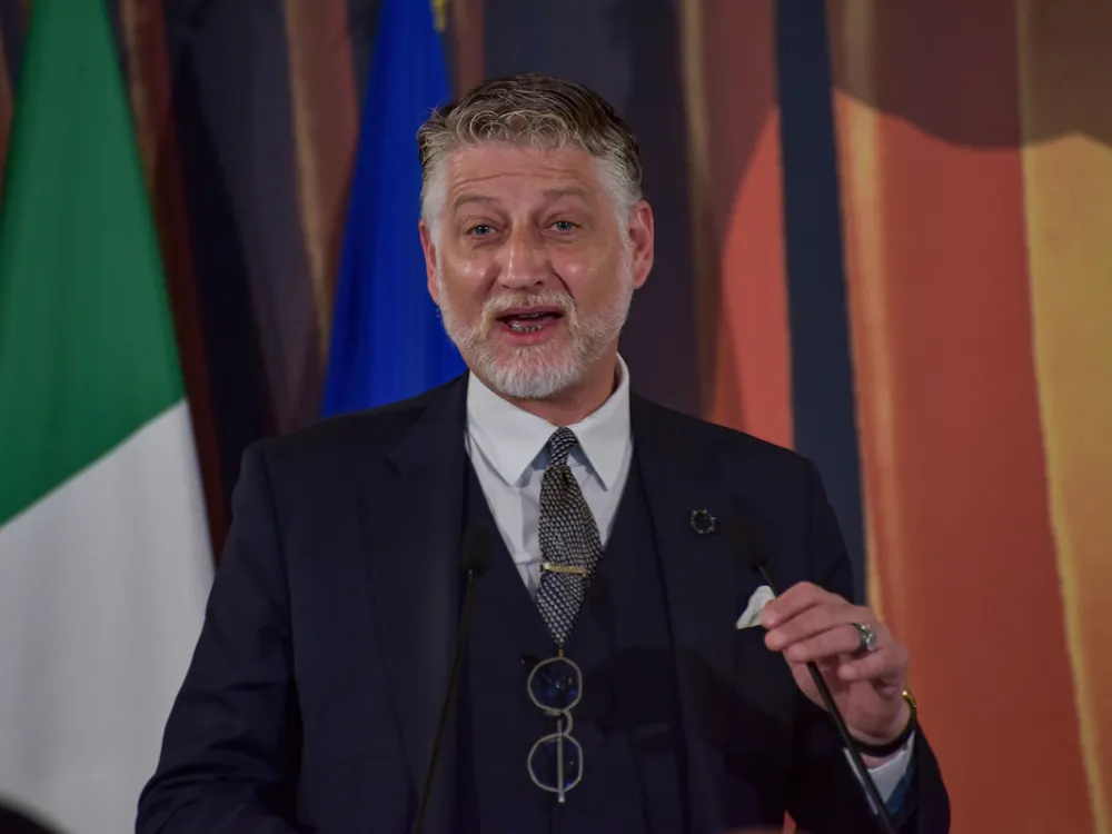 A man speaking at a microphone.