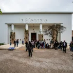 People walking toward a pavilion marked with 