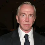 Portrait of a white man in a suit and tie.