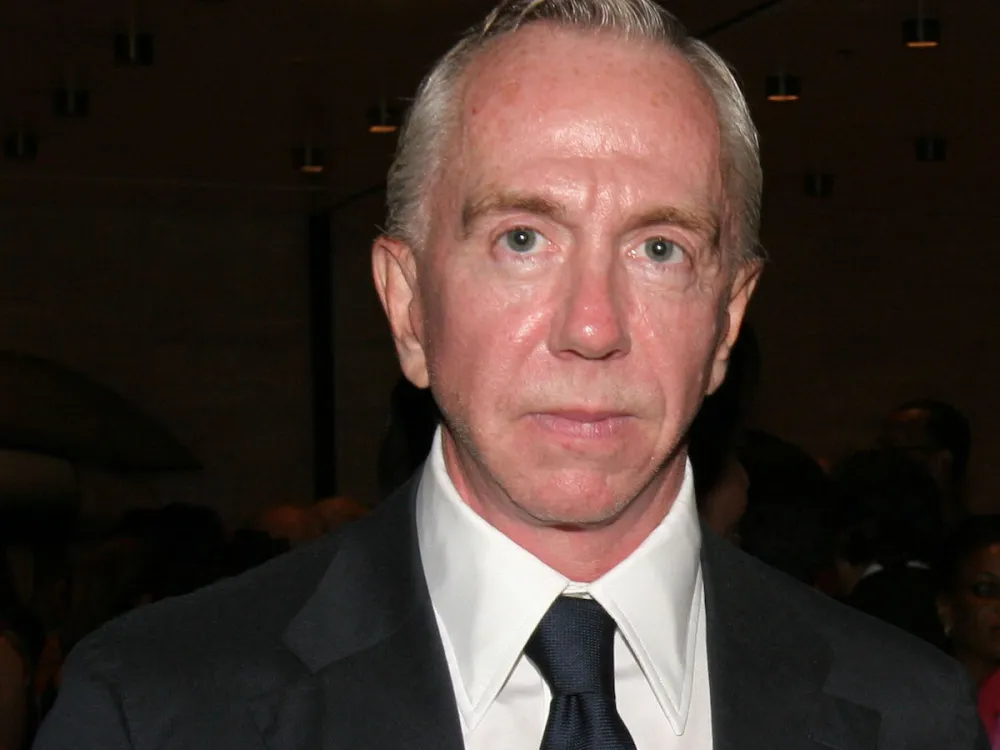 Portrait of a white man in a suit and tie.