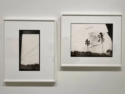 Two photographs hand on a wall.
