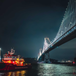 A boat next to a bridge
