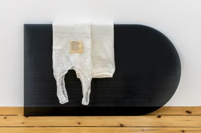 A silky underwear draped over a translucent black object.
