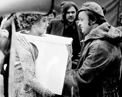 A man reaches into a box around a women