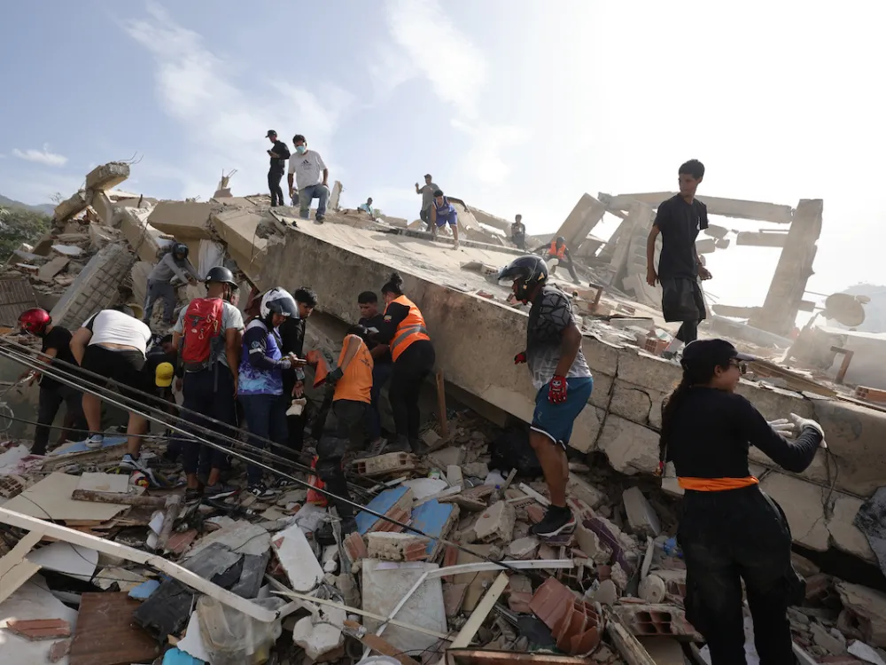 People on top of a destroyed building.