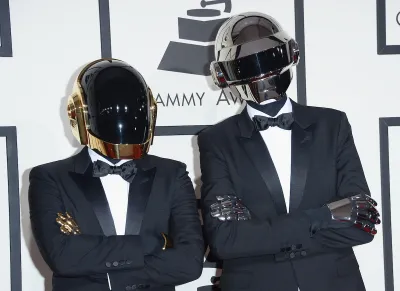 Two figures in tuxes and robot helmets.