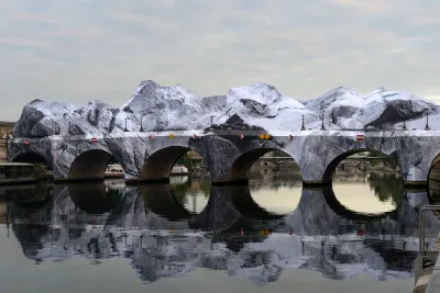 A bridge covered in white fabric that looks like a rocky crag.