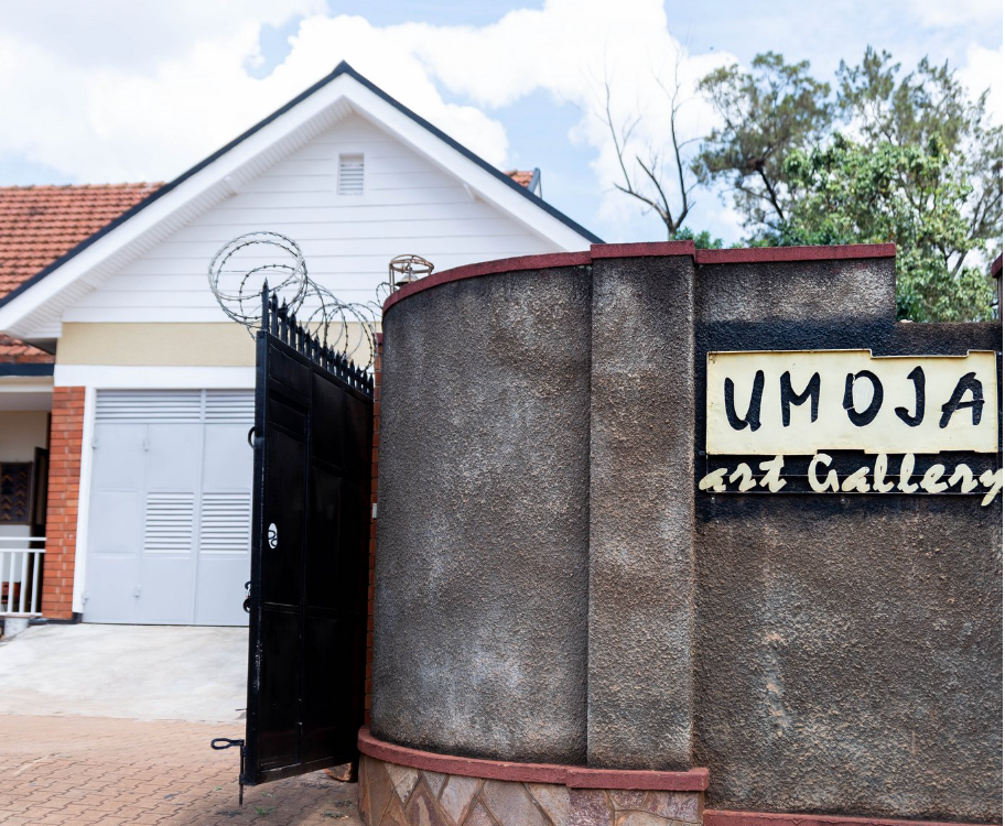a home with a curved wall with a sign that says Umoja art gallery