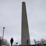 Charlestown, MA - February 27: A visitor was silhouetted as he stood at the base of Bunker Hill Monument. National Park Service staff in Boston are in disarray after recent personnel cuts, and a freeze on seasonal hiring could mean that heavily visited sites such as Bunker Hill could see fewer rangers this summer and reduced hours at the museum there. (Photo by Jessica Rinaldi/The Boston Globe via Getty Images)