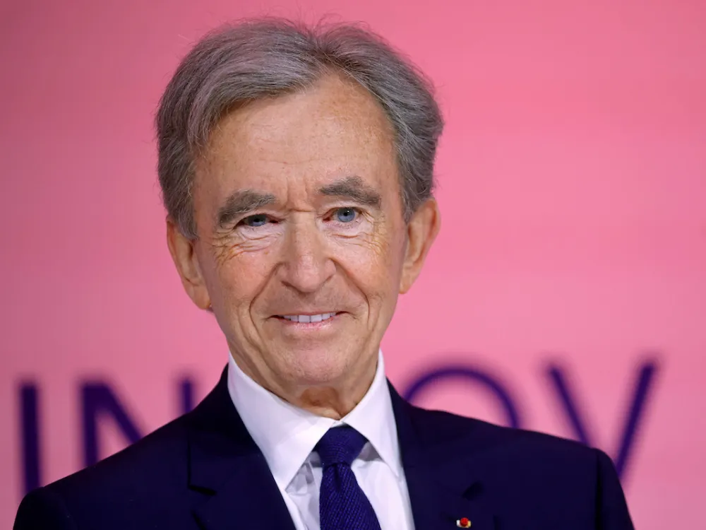 A smiling man in a suit.
