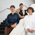Three women on a staircase.