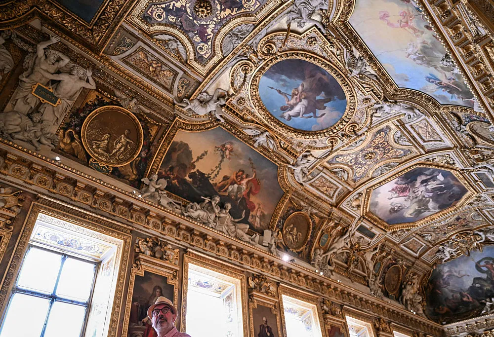 A visitor looks on during the reopening to the public of the Apollo Gallery, where French crown jewels worth 88 million euros were stolen in 2025 in a brazen heist, at the Musée du Louvre in Paris on July 22, 2026. (Photo by LOU BENOIST / POOL / AFP via Getty Images)