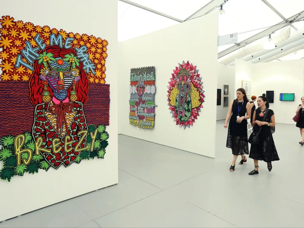 Colorful large felt collages by Jody Paulsen of South Africa hang on white walls at SMAC Gallery