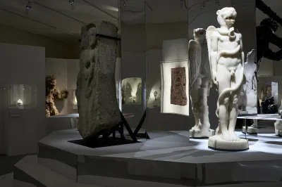 View of a museum exhibition with art from various centuries on display.