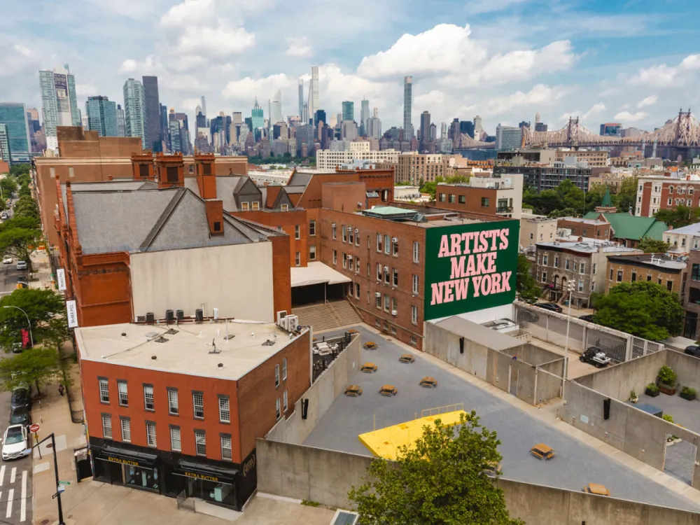 Aerial view of MoMA PS1, with a sign that reads