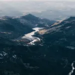 An aerial view of a river coursing through mountains.