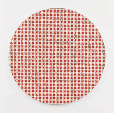 A circular painting of a rough-hewn gingham pattern in red, white and pink with some green marks.