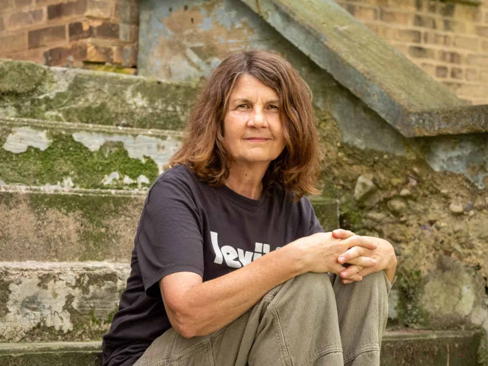 Portrait of Michelle Grabner sitting on a stoop.