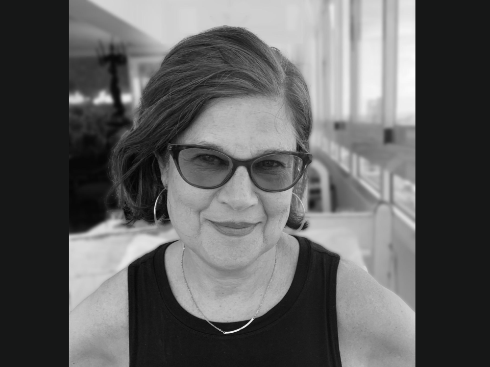 A black and white portrait of a woman in sunglasses.