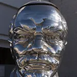 Chrome bust of Russian Communist leader Vladimir Lenin in West Hollywood, California. The piece is "Miss Mao Trying to Poise Herself at the Top of Lenin