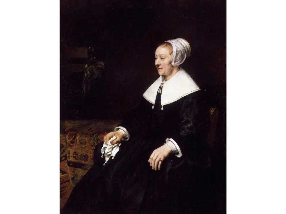 A wealthy 17th-century Dutch woman sits in an interior.
