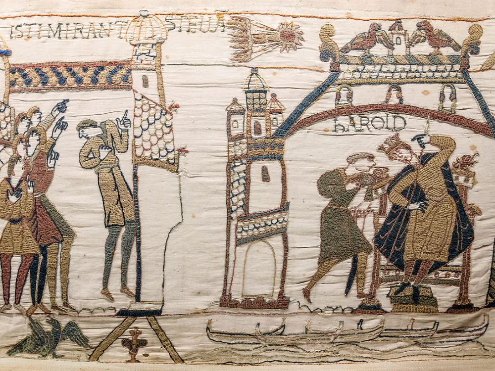 A detailed part of the ancient Bayeux Tapestry showing a king and his minions.