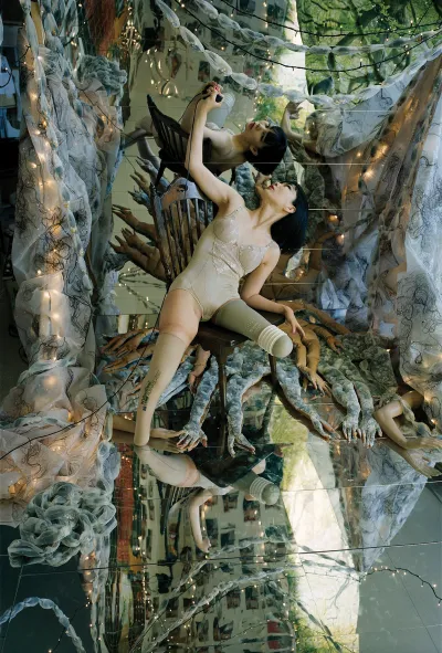 An image of a woman in a fantastical setting who looks at her reflection.