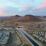 Overhead shot of a canal coursing through similar-looking houses.