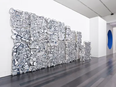 A large-scale sculpture by Jean Dubuffet consisting of various abstract forms against a wall.