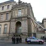 French police officers stand next to a furniture elevator used by robbers to enter the Louvre Museum, on Quai Francois Mitterrand, in Paris on October 19, 2025. Robbers broke in to the Louvre and fled with jewellery on October 19, 2025 morning, a source close to the case said, adding that its value was still being evaluated. A police source said an unknown number of thieves arrived on a scooter armed with small chainsaws and used a goods lift to reach the room they were targeting. (Photo by Dimitar DILKOFF / AFP) (Photo by DIMITAR DILKOFF/AFP via Getty Images)