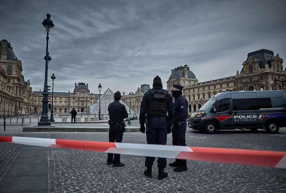 PARIS, FRANCE - OCTOBER 19: French Police officers seal off the entrance to the Louvre Museum after a Jewllery Heist on October 19, 2025 in Paris, France. France