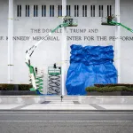 A blue tarp is dropped after the renaming of The John F. Kennedy Memorial Center for the Performing Arts in honor of US President Donald Trump on December 19, 2025, in Washington, DC. The US capital