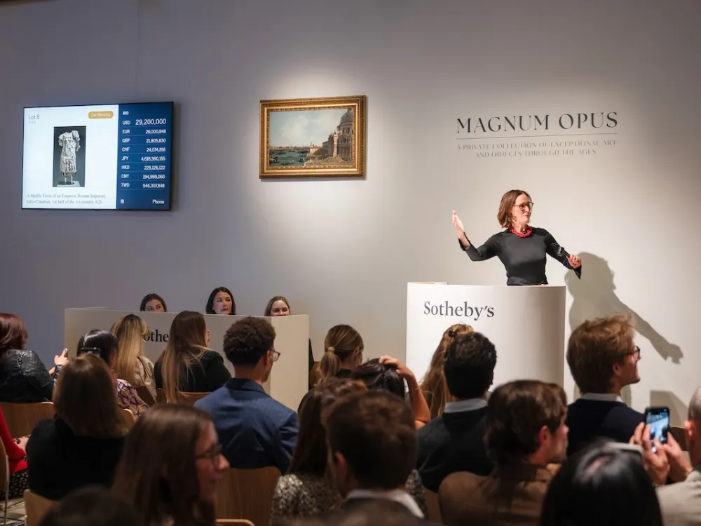 A woman at a rostrum before a crowd.