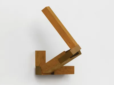 A wooden sculpture that juts out from the wall at two different angles.