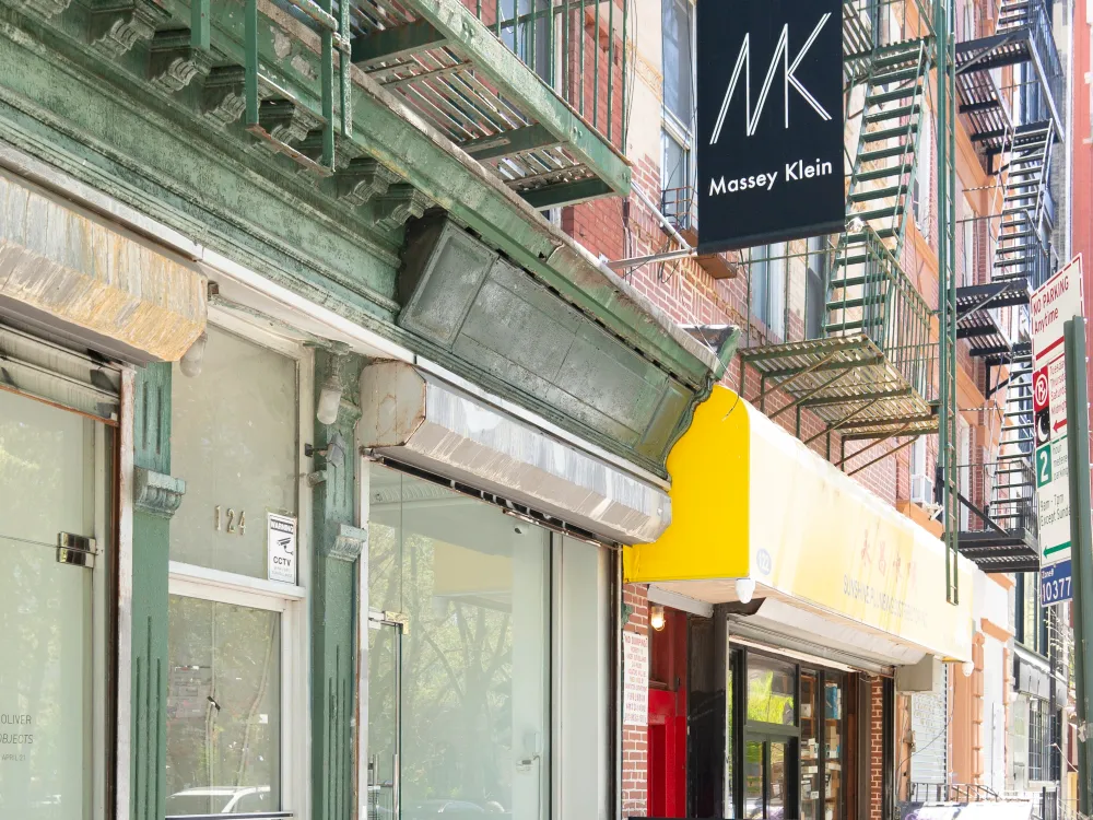 A photo shows a storefront on a New York street with a sign reading Massey Klein.