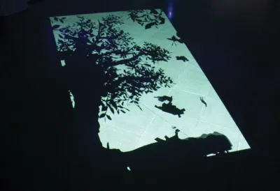 A silhouette projected onto a floor.