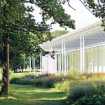 A building surrounded by a lush garden (in the foreground).
