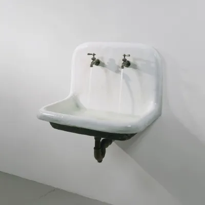 An artwork of a functioning porcelain sink with two facets running.