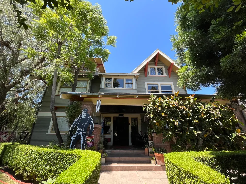 A photo shows a house in Los Angeles with a cutout figure of a Tom of Finland