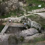 This picture shows a natural pool of water in the centre of the Palestinian village of Lifta, which was abandoned during fighting in the 1948 Arab-Israeli war, on the outskirts of Jerusalem, on December 30, 2022. Lifta, a rare example of a still existing abandoned Palestinian village, lies in a bucolic spot at the entrance to Jerusalem, and is at the centre of a preservation fight over an Israeli plan to build villas there.The village, in mainly Jewish west Jerusalem, is on a tentative list of UNESCO World Heritage sites. The World Monuments Fund organisation has put it on its list of sites under threat.