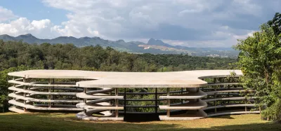 A concrete structure in a lush landscape.