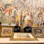 Carabinieri pose near three paintings stolen from the Fondazione Magnani Rocca and recovered following a police operation.